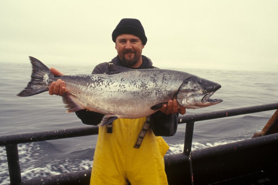man carrying silver fish