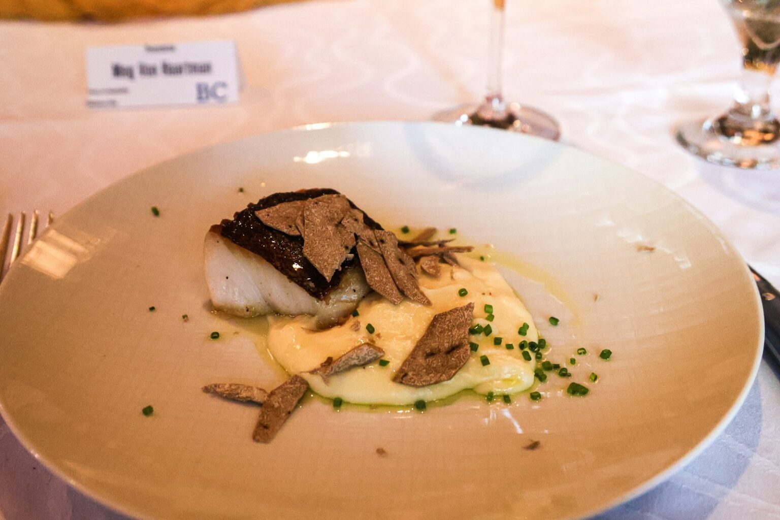 A white plate topped with food on top of a table