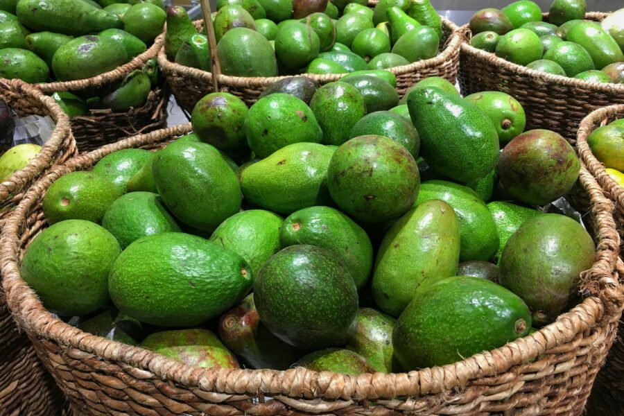 green fruits on brown woven basket