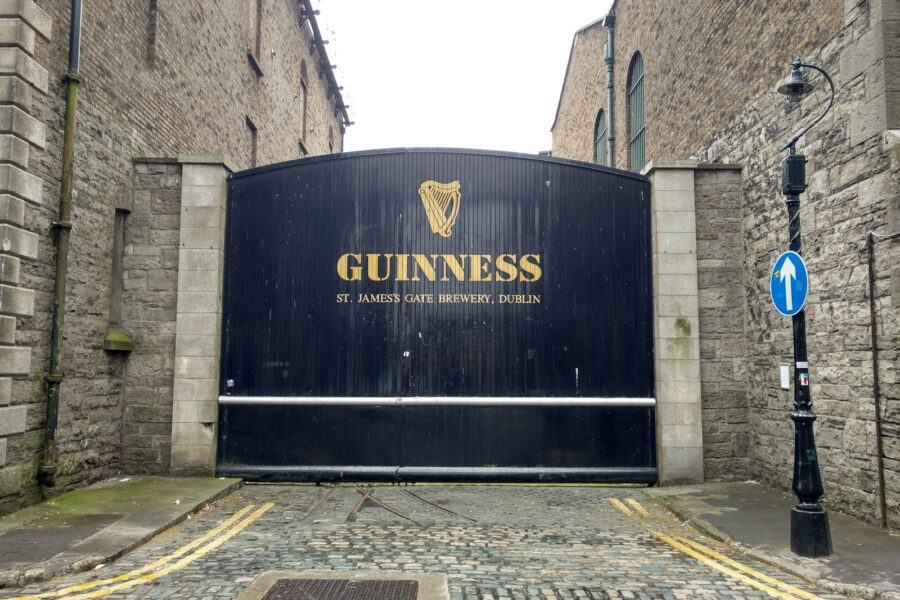 a guinness sign in front of a brick building
