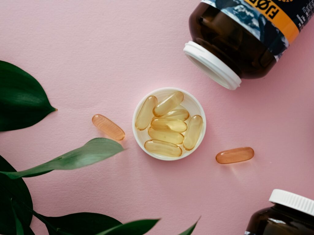 a bowl of fish oil next to a bottle of fish oil