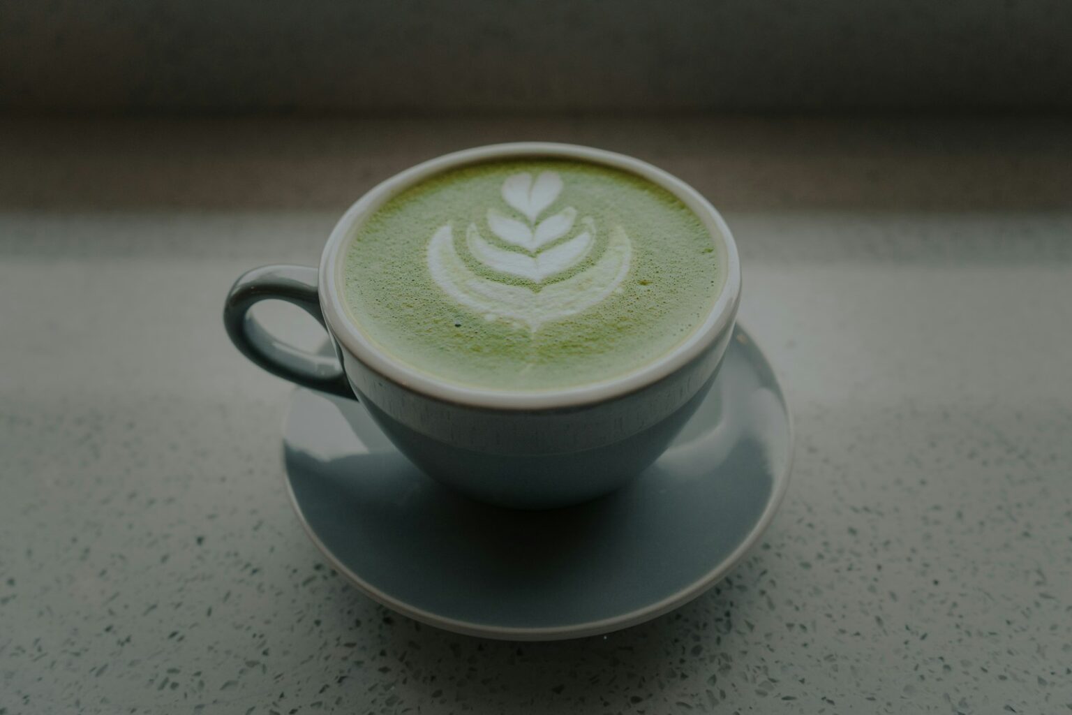 grey ceramic mug with grey saucer