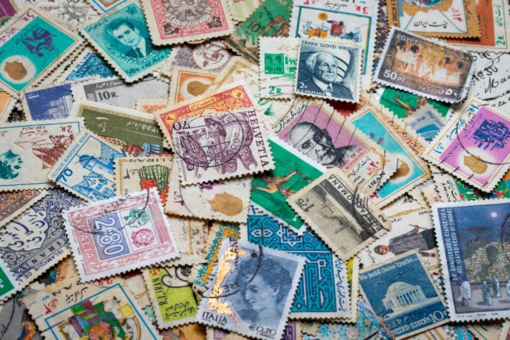 assorted postage stamps on blue and white textile