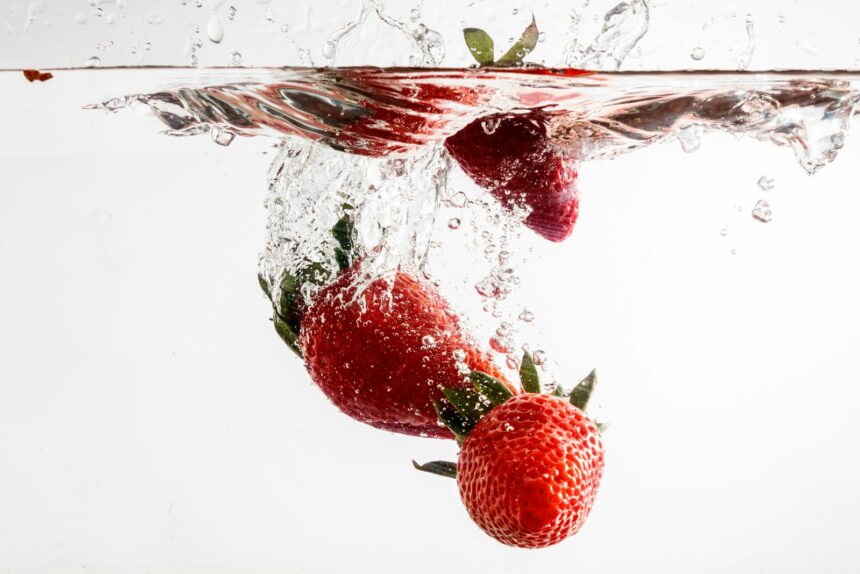 red strawberries in clear glass container