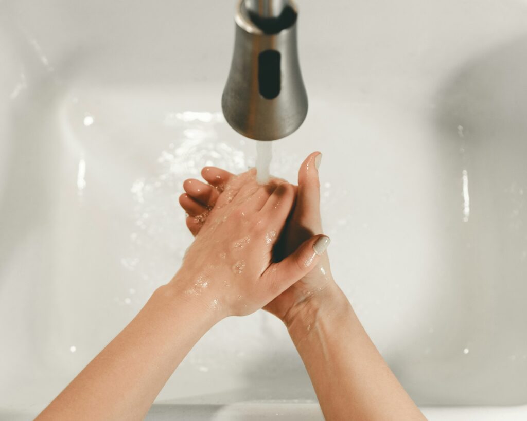 persons feet on white bathtub