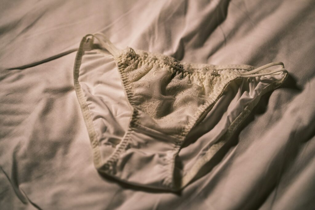 a bra that is laying on a bed