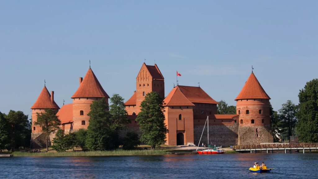 a boat is in the water in front of a castle