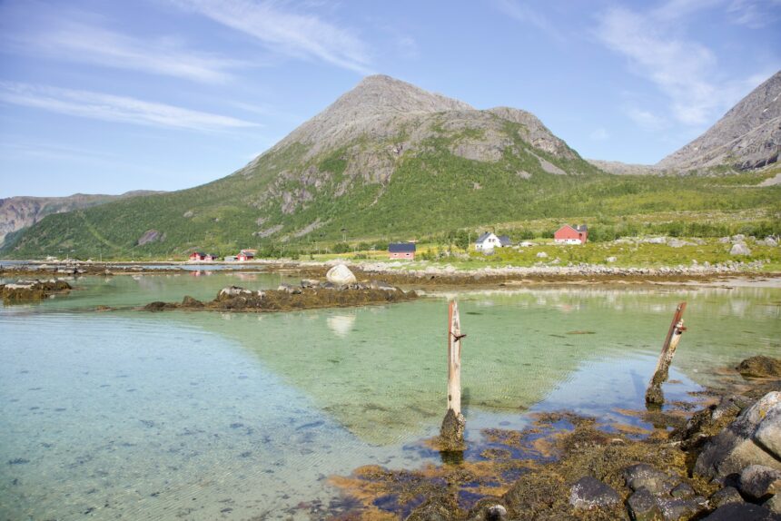 a body of water with a hill in the background