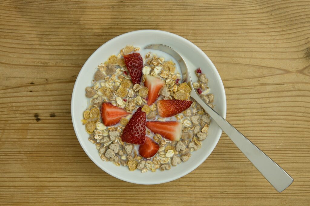 a bowl of oatmeal with strawberries and nuts